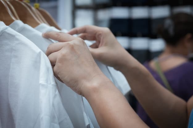 A close-up shot of a woman's hands selecting a high-quality cotton t-shirt from a rack in a store, emphasizing the importance of choosing durable materials for a capsule wardrobe from Shein.