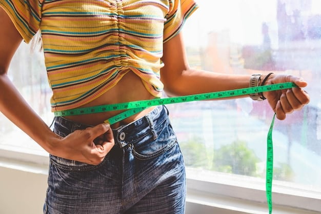 Close-up of a person carefully measuring their waist with a measuring tape, with a Shein size chart visible in the background on a computer screen. The focus is on the precision and attention to detail in taking accurate measurements.
