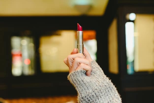 A close-up shot of a woman applying bright red lipstick, with focus on the lipstick tube and her perfectly manicured hand. The background is blurred, showcasing a vanity with makeup products.