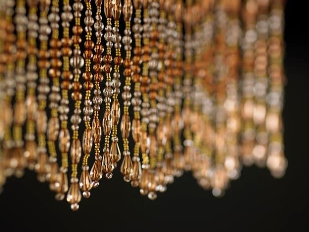 A close-up shot of different types of necklaces (gold, silver, pearl) laid out on a table next to a little black dress, highlighting the textures and styles that complement the dress.
