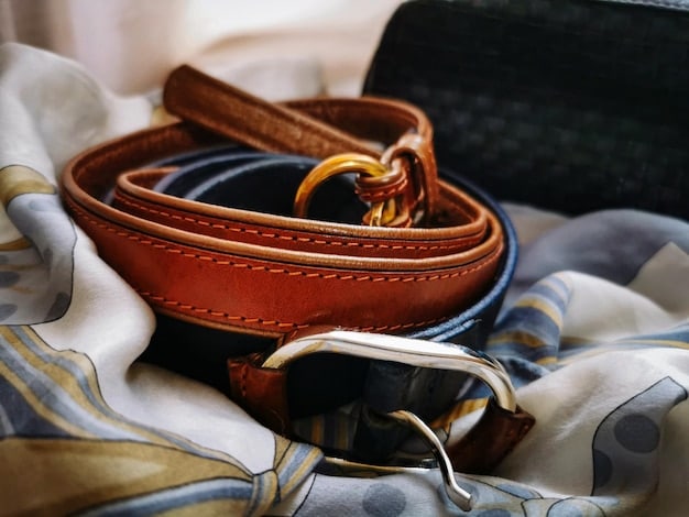 A close-up of an elegant silk scarf tied around the handle of a classic leather handbag, with the focus on the luxurious texture of the silk and the rich color of the leather. The background is blurred, highlighting the accessories as the main subject.